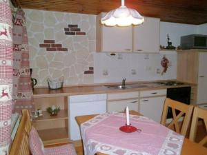 a small kitchen with a table with a candle on it at Bayerischer Rückzugsort in der Nähe des Chiemsees in Übersee