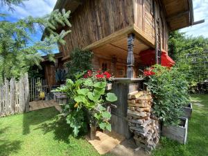 a wooden house with flowers in the yard at Bayerisches Refugium mit Sauna in Tittmoning