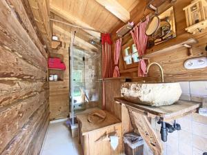 a bathroom in a wooden cabin with a sink at Bayerisches Refugium mit Sauna in Tittmoning +31 photos