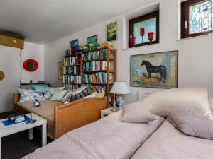 a bedroom with two beds and a book shelf at Flat in Meldorf next to the town centre in Meldorf