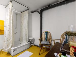 a room with a shower and a chair and a table at Flat in Meldorf next to the town centre in Meldorf