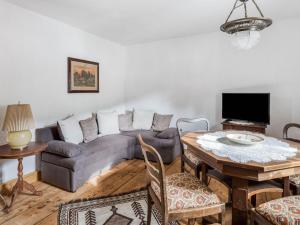 a living room with a couch and a table at Cosy holiday home in Bardolino with swimming pool in Wolfsberg