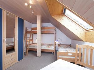 a room with three bunk beds in a house at Modern Apartment in Waldachtal near the Forest in Waldachtal