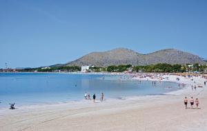 a group of people on a beach in the water at Lovely Home In Alcúdia in Alcudia
