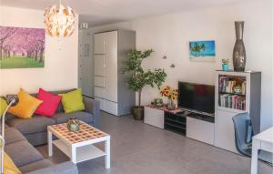 a living room with a couch and a tv at 4 Bedroom Stunning Apartment In Mlaga in Málaga