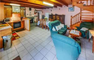 a living room with a blue couch and a kitchen at Holiday Home Riantec Rue De Kerner in Riantec