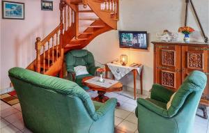 a living room with two chairs and a staircase at Beautiful Home In Riantec With 3 Bedrooms in Riantec