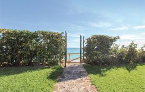 a gate to the beach with the ocean in the background at Awesome Apartment In Altea With Wifi in Altea