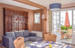 a living room with a couch and a table at Two-Bedroom Holiday Home In Saint Cast Le Guildo in LʼIsle-Saint-Cast +13 photos