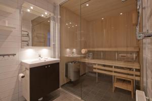 a bathroom with a sink and a shower and a toilet at Funäs Ski Lodge in Funäsdalen +123 photos
