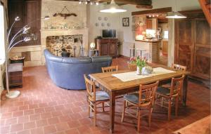 a living room with a wooden table and a blue couch at Chouchou, Le Bourg in Laveyssière