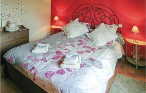 a bedroom with a large bed with a red wall at Chouchou, Le Bourg in Laveyssière