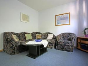 a living room with a couch and a table at Secluded Apartment in Medebach with Terrace in Medebach