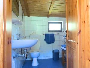 a small bathroom with a sink and a toilet at Charming apartment with private terrace in Bad Wildungen