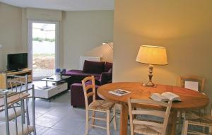 a living room with a table with a lamp and a couch at Gorgeous Home In Plouha With Kitchenette in Plouha