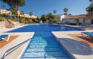 ein Swimmingpool in einem Resort mit Palmen in der Unterkunft Awesome Home In Mijas Costa With Wifi in Mijas Costa
