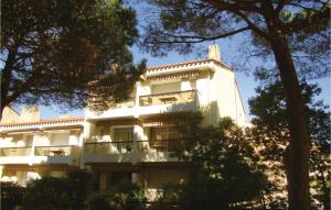 een wit gebouw met bomen ervoor bij Amazing Apartment In Argeles Sur Mer With Kitchen in Plage dʼArgelès