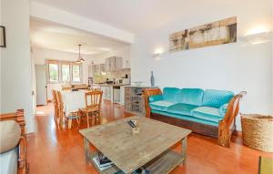 a living room with a blue couch and a table at Beautiful Home In Sartene With Wifi in Sartène