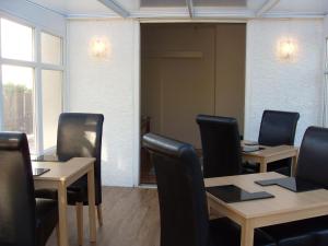 a conference room with tables and chairs and a window at Dol Aur - Room Only in Harlech