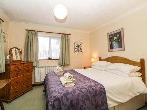 ein Schlafzimmer mit einem großen Bett mit Handtüchern darauf in der Unterkunft Broom Cottage in Sidmouth