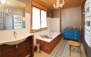 a bathroom with a sink and a bath tub and a sink at Cozy Home In Thezan-Les-Béziers in Thèzan-lès-Béziers +28 photos