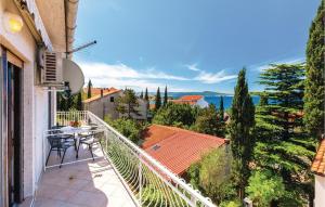 a balcony of a house with a table and chairs at Gorgeous Apartment In Selce With Wifi in Selce