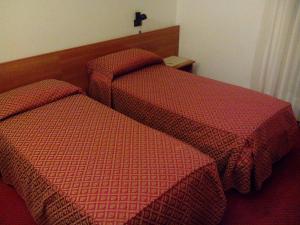Un pat sau paturi într-o cameră la Albergo Alla Speranza