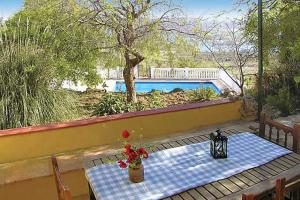 a table with a blue and white checkered table cloth on a patio at La Casita in Periana