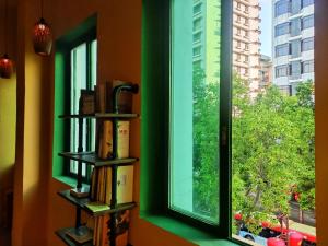 a window with a bunch of books on it at Foshan Cuba Youth Hostel in Foshan