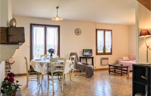 a living room with a table and a dining room at Holiday Home Rue De Seychelles in Pirou +11 photos