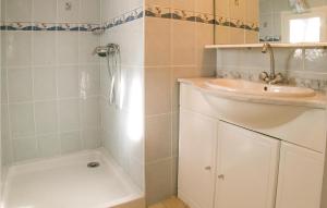 a white bathroom with a sink and a shower at Three-Bedroom Holiday Home In La Tranche Sur Mer in La Tranche-sur-Mer