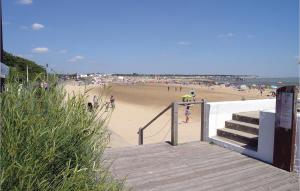 a beach with a bunch of people on the sand at Three-Bedroom Holiday Home In La Tranche Sur Mer in La Tranche-sur-Mer