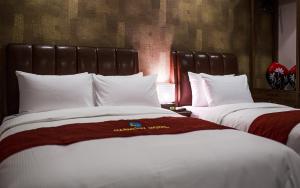 Postel nebo postele na pokoji v ubytování Harmony Hotel