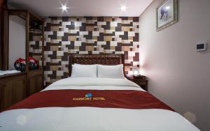 Postel nebo postele na pokoji v ubytování Harmony Hotel
