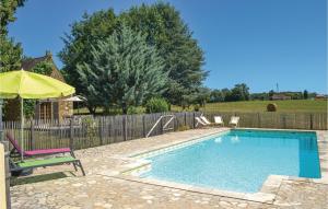 a swimming pool with a chair and an umbrella at Lovely Home In Campsegret With Private Swimming Pool, Can Be Inside Or Outside in Campsegret