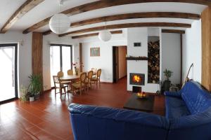 a living room with a blue couch and a fireplace at Malowane Wrota in Łazy