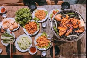 a table with many plates of food on it at Tam Coc Valley Homestay in Ninh Binh