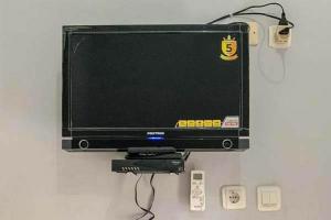 a flat screen tv sitting on top of a wall at Kai Homestay Near Anyer Beach RedPartner in Kareo