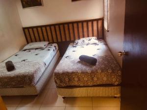 two twin beds in a room with a door at Beach view apartment from balcony in Banting +5 photos