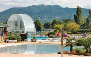 a large swimming pool with a glass building in the background at Nice Home In Mirabel Aux Baronnies With 3 Bedrooms And Wifi in Mirabel-aux-Baronnies