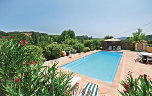 a large swimming pool in a yard with a patio at Amazing Home In Salernes With Wifi in Salernes