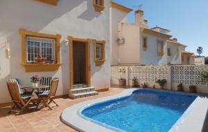 a house with a swimming pool on a patio at Lovely Home In Orihuela Costa With Kitchen in Cabo Roig