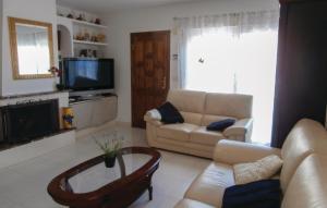 a living room with a couch and a tv at Lovely Home In Orihuela Costa With Kitchen in Cabo Roig