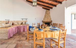 a dining room with a table and a fireplace at Beautiful Home In Periana With Kitchen in Periana