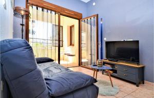 a living room with a couch and a flat screen tv at 2 Bedroom Amazing Apartment In Uzes in Uzès
