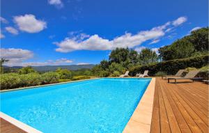a swimming pool with two chairs on a wooden deck at Stunning Home In Saignon in Saignon