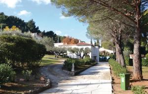 a walkway in a yard with trees and a house at Awesome Home In Toulon in Toulon
