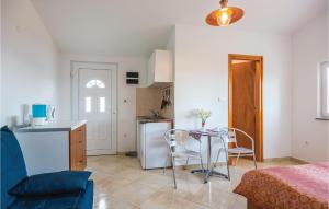 a living room with a table and a kitchen at Nice Home In Martina With Kitchen in Martina