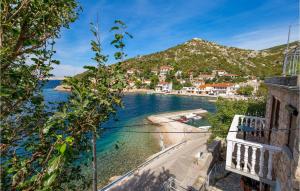 a view of a beach in a town next to the water at Cozy Apartment In Starigrad With Kitchen in Starigrad