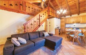 a living room with a couch and a kitchen at Maso Roncal in Peio